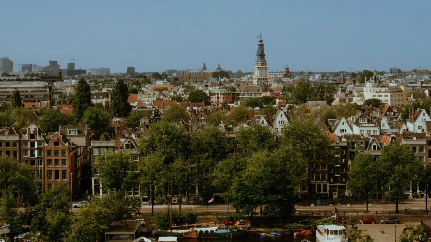 A wide aerial view across an entire city of thousands of buildings, the many places the embedding is learned across at once.